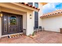 A home's front door with wreath, decor and sidelight windows for natural light at 17012 N 57Th St, Scottsdale, AZ 85254