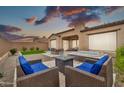 Relaxing backyard featuring a spa, outdoor seating area, lush turf, and privacy wall, perfect for outdoor living at 17913 W Sunward Dr, Goodyear, AZ 85338