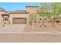 Inviting single-Gathering home displaying low-maintenance desert landscaping and an attached two-car garage at 17913 W Sunward Dr, Goodyear, AZ 85338
