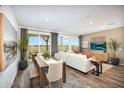Spacious living and dining area filled with natural light and featuring modern decor at 18066 W Sand Hills Dr, Surprise, AZ 85387
