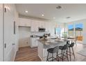 Bright, modern kitchen with white cabinets, granite countertops, and stainless steel appliances at 18072 W Sand Hills Dr, Surprise, AZ 85387