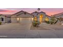 Charming home with a three-car garage, landscaped front yard, and a covered entryway, perfect for welcoming guests at 186 N Starboard Dr, Gilbert, AZ 85234