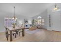 Bright living room and dining area featuring hardwood floors, vaulted ceilings, and lots of natural light at 186 N Starboard Dr, Gilbert, AZ 85234