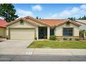 Charming single-story home with a well-maintained lawn, mature shrubs, and a two-car garage at 1918 E Anchor Dr, Gilbert, AZ 85234