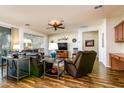 Open-concept living room with wood floors, cozy furniture, and a ceiling fan for added comfort at 20183 N Big Dipper Dr, Maricopa, AZ 85138