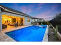 Captivating backyard featuring a sparkling pool, covered patio, and outdoor cooking area for luxurious outdoor living at 20373 W Coolidge St, Buckeye, AZ 85396