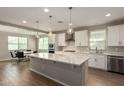 Bright open-concept kitchen with an island, stainless steel appliances, and adjacent dining area at 23020 E Excelsior Ave, Queen Creek, AZ 85142