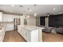 Spacious open-concept kitchen with island, stainless steel appliances, and adjoined to living area at 23020 E Excelsior Ave, Queen Creek, AZ 85142