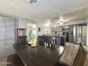 Open kitchen and dining area featuring gray cabinets and stainless steel appliances at 2329 E Juanita Ave, Mesa, AZ 85204