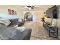 Inviting living room with a comfortable couch, plush rug, and a modern entertainment center at 2329 E Juanita Ave, Mesa, AZ 85204