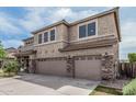 Side view of a two-story home with a three-car garage and landscaped yard at 26011 W Tonopah Dr, Buckeye, AZ 85396
