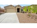 Charming single-story home featuring a well-manicured front yard and attached two-car garage at 31096 N 133Rd Ave, Peoria, AZ 85383
