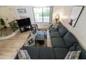 Cozy living room with blue sectional, patterned rug, and modern decor provides a comfortable and stylish space at 3324 S Juniper St, Tempe, AZ 85282