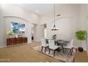 Elegant dining room featuring modern chandelier, stylish furniture, and decorative wall art at 4817 E Cielo Grande Ave, Phoenix, AZ 85054