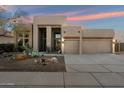 Charming single-story home featuring a landscaped front yard and a two-car garage with wooden beam accents at 4817 E Cielo Grande Ave, Phoenix, AZ 85054