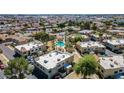 Aerial view of a well-planned community featuring a sparkling pool and mature trees at 4828 W Rancho Dr, Glendale, AZ 85301