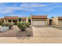 Exterior shot of home with red tile roof and desert landscaping and attached two car garage at 5358 S Farmer Ave, Tempe, AZ 85283