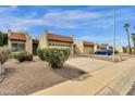Charming street view of homes with desert landscaping, red tile roofs and attached two car garages at 5358 S Farmer Ave, Tempe, AZ 85283
