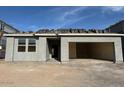 New single-story house under construction with a gray exterior at 5551 S 240Th Ln, Buckeye, AZ 85326
