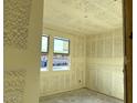 Unfinished room with windows overlooking a landscaped area at 5551 S 240Th Ln, Buckeye, AZ 85326