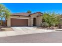 Charming single-story home with a tile roof, desert landscaping, and a two-car garage at 6413 S 47Th Dr, Laveen, AZ 85339