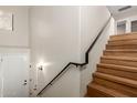Staircase with black handrail and light wood finish leading to the upper level at 705 W Queen Creek Rd # 2078, Chandler, AZ 85248