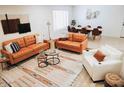 Bright and airy living room with stylish furniture, decor, and wood-style flooring at 7412 S Elm St, Tempe, AZ 85283