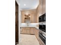 Modern kitchen featuring custom cabinets, stainless steel appliances, and stone countertops at 8601 N 59Th Pl, Paradise Valley, AZ 85253