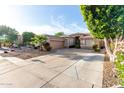 Well maintained single-story home with an extended driveway and desert landscaping at 9908 E Medina Ave, Mesa, AZ 85209