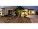 Charming single-story home exterior view showcasing landscape at twilight at 9908 E Medina Ave, Mesa, AZ 85209