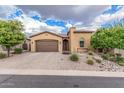 Charming single-story home with desert landscaping, a paver driveway, and a two-car garage at 10713 N 124Th Pl, Scottsdale, AZ 85259