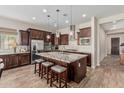 Spacious kitchen with granite counters, stainless appliances, mosaic backsplash and central island with barstool seating at 10713 N 124Th Pl, Scottsdale, AZ 85259