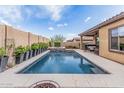 Inviting backyard features a sparkling pool, raised spa, and covered patio for outdoor entertainment at 10713 N 124Th Pl, Scottsdale, AZ 85259