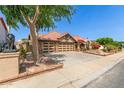 Inviting home with three-car garage, clay tile roof, mature shade trees, and charming courtyard entry at 1114 W Meseto Ave, Mesa, AZ 85210
