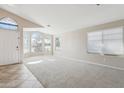 Inviting living room with large windows, neutral carpet, and a view of the exterior, enhancing the home's appeal at 11351 N 153Rd Dr, Surprise, AZ 85379