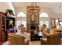 Inviting living room with stone fireplace, high ceilings, and neutral decor at 12749 E Poinsettia Dr, Scottsdale, AZ 85259
