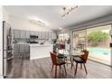 Open kitchen and breakfast nook with stainless appliances and backyard pool view at 1425 E Darrel Rd, Phoenix, AZ 85042