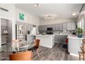 Bright kitchen with gray cabinets, stainless steel appliances, and a glass dining table at 1425 E Darrel Rd, Phoenix, AZ 85042