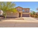 Tan two-story home with a front-facing two-car garage and low-maintenance desert landscaping at 1524 N Milly Pl, Casa Grande, AZ 85122