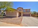Front exterior of a two-story home with desert landscaping and an attached garage at 1524 N Milly Pl, Casa Grande, AZ 85122