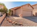 Charming single-Gathering home featuring a two-car garage, low maintenance landscaping, and a cozy front porch at 19412 N 77Th Ave, Glendale, AZ 85308