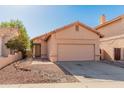 Inviting single-Gathering home boasting a two-car garage, neutral paint scheme, and easy-care landscaping at 19412 N 77Th Ave, Glendale, AZ 85308