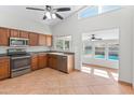 Well-equipped kitchen with stainless steel appliances, ample cabinetry, and a view of the backyard pool at 19412 N 77Th Ave, Glendale, AZ 85308