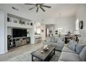 Bright living room with stylish furniture, vaulted ceilings, and wood-look tile floors at 19475 N Grayhawk Dr # 1046, Scottsdale, AZ 85255