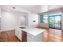 Kitchen island with stainless steel dishwasher and sink, plus lots of natural light and hardwood floors at 3131 N Central Ave # 7002, Phoenix, AZ 85012