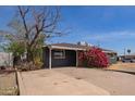 Charming single-story home featuring a dark gray brick exterior and a well-manicured front yard at 3222 W Marshall Ave, Phoenix, AZ 85017