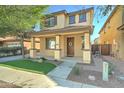 Welcoming two-story home featuring a cozy front porch, desert landscaping, and charming architectural details at 3455 E Oakland St, Gilbert, AZ 85295