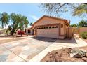 Attractive home featuring a patterned driveway, desert landscaping and a two-car garage at 4010 N 156Th Ln, Goodyear, AZ 85395