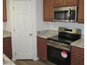 Stainless steel oven with granite countertops and wood cabinets at 41246 N Vine Ave, San Tan Valley, AZ 85140