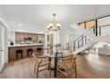Open dining area with contemporary lighting, open stairwell and connected to the kitchen at 4323 N Miller Rd, Scottsdale, AZ 85251